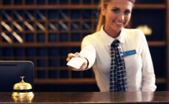 Hotel-Reception-Woman-issue-hotel-key-card-to-guests